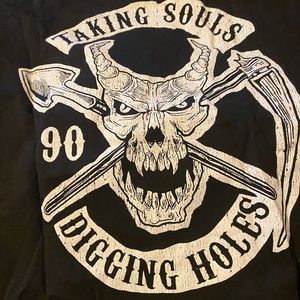 Undertaker shirt.  Taking souls and digging holes